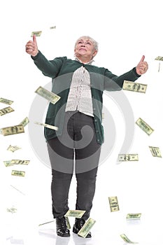 Positive surprised woman showing double thumbs up as money are falling like a rain of dollars from the sky.