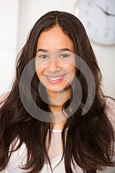 Positive teenager girl smiling at home