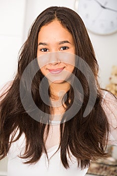 Positive teenager girl smiling at home