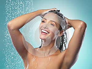 Positive thinking and good hygiene can keep diseases away. a young woman washing her hair in the shower against a blue