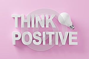 Positive thinking and optimism in business or life concept. The word think positive with an idea light bulb on pink background