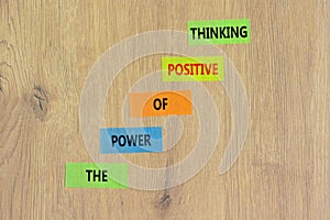 Positive thinking symbol. Concept words The power of positive thinking on colored paper. Beautiful wooden table wooden background