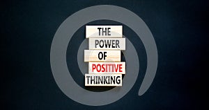 Positive thinking symbol. Concept words The power of positive thinking on wooden block. Beautiful black table black background.