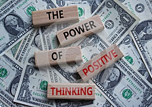 Positive Thinking symbol. Wooden blocks with words The Power of Positive Thinking. Beautiful dollar background. Positive Thinking