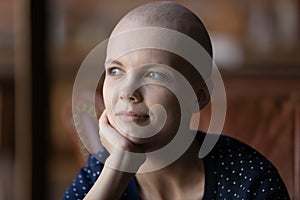 Positive thoughtful young hairless woman with cancer portrait