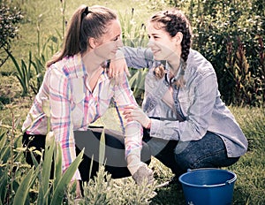 Positive two young females working in the outdoor