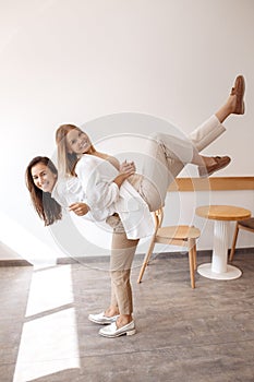 Positive two young women friends having fun at the cafe indoors.