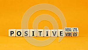 Positive vibes result symbol. Concept words Positive vibes or Positive results on cubes. Beautiful orange table orange background