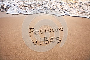 positive vibes, text on sand, optimism