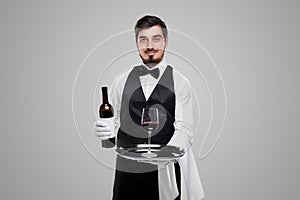 Positive waiter offering wine to guest