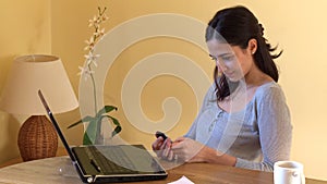 Positive woman at computer sending a text message