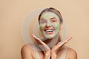 Positive Woman with Face Mask. Spa Face Mask. Skin Care Beauty Treatment