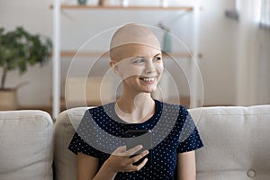 Positive woman having oncology relax at home using cell