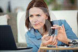 positive woman learning how to fix machine