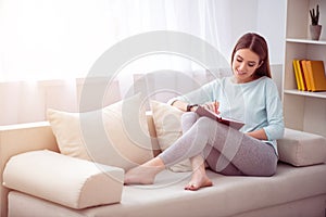 Positive woman resting on the couch