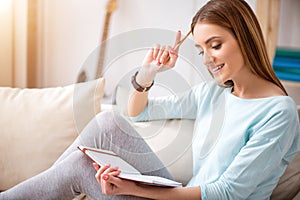 Positive woman resting on the couch