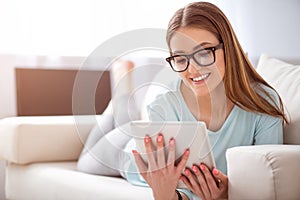 Positive woman resting on the couch