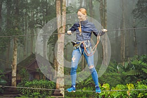 Positive woman spending her free time in the adventure park