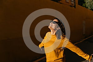 Positive woman in sunglasses on street