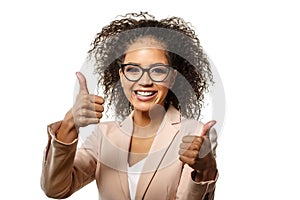 Positive Woman surprise showing product. Attractive young female with Afro hairstyle presenting product. Girl points aside with