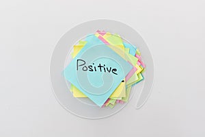 Positive word hand written on a sticky note