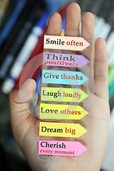 Positive words in hand. Todays goals list. Morning inspirational words - Smile often. Think positively. Give thanks. Laugh loudly photo