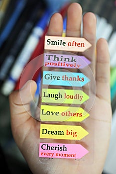 Positive words in hand. Todays goals list. Morning inspirational words - Smile often. Think positively. Give thanks. Laugh loudly