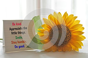 Positive words on notepaper -  Be kind. Appreciate the little things. Smile. Stay humble. Do good.