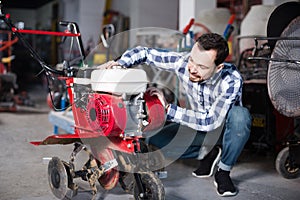 Positive working man practicing his skills with plough