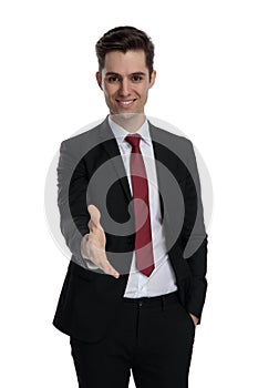 Positive young businessman giving a handshake