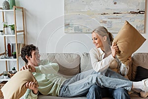 positive young couple smiling while having