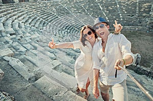 Positive young couple take self photo in Side amphitheatre