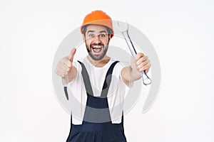 Positive young man builder holding wrench