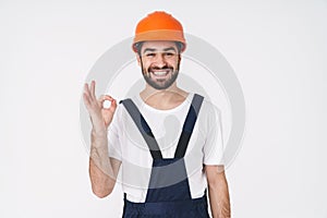 Positive young man builder showing okay gesture