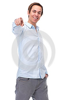 Positive young man pointing finger and smiling