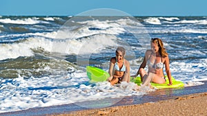 Positive young woman and her daughter bathe