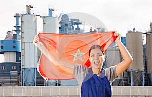 Positive young woman holds the national flag of Morocco