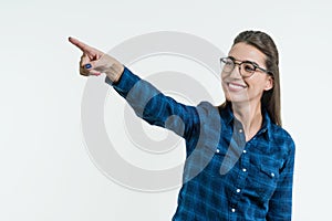 Positive young woman pointing his finger on abstract light background, touching a digital button on a abstract screen, virtual int