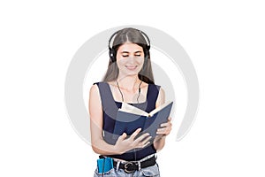 Positive young woman reading a books while listening to music isolated on white background