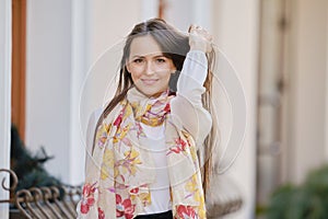 Positive young woman touching her long hair