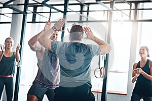 Positivity can be so contagious. a fitness group celebrating a victory at the gym.