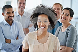 Positivity is the foundation of our success. Portrait of a group of diverse colleagues standing in an office.