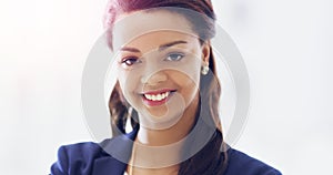 Positivity leads to success. Cropped portrait of an attractive young businesswoman smiling happily in her office.