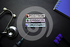 Positron Emission Tomography text on Sticky Notes. Top view isolated on black background. Healthcare/Medical concept