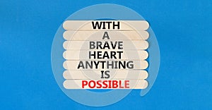 Possible symbol. Concept words With a brave heart anything is possible on wooden stick on beautiful blue table blue background.