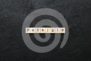 possible word written on wood block. possible text on table, concept