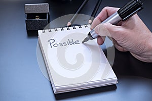 Possible is written on small notepad