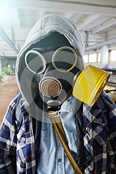 Post-apocalyptic.The guy in the gas mask stands in an abandoned building photo