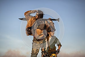 Post-apocalyptic Woman and Boy Outdoors in a Wasteland