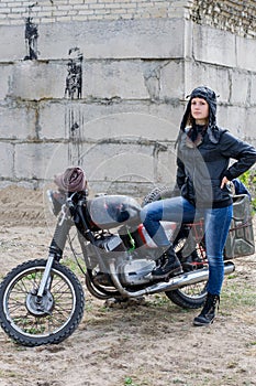 A post apocalyptic woman near motorcycle near the destroyed building